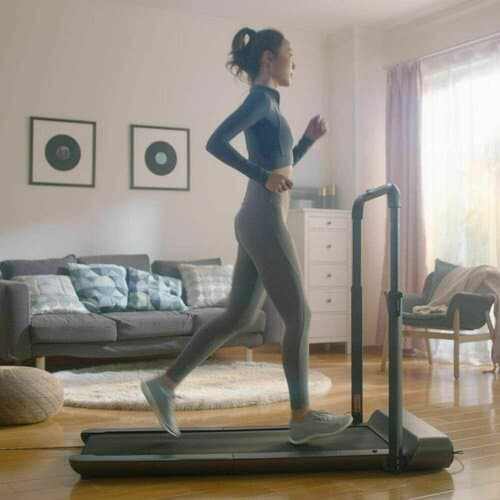 a lady running on walkingpad r1 pro in her house with furniture in the background